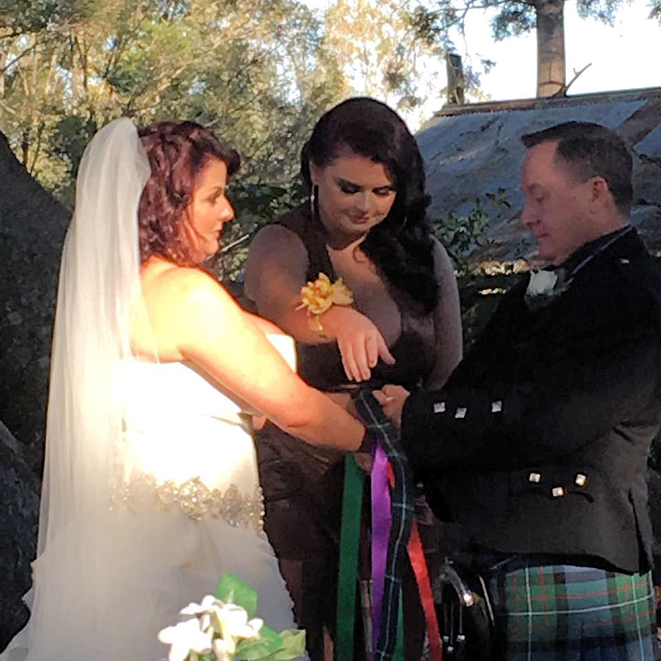 Handfasting using a tartan band plus coloured
                  ribbons