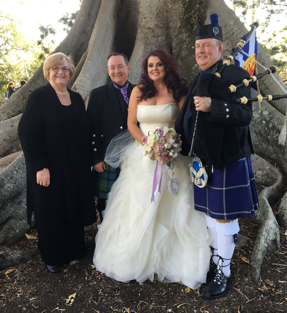 Jennifer Cram with couple and Piper Joe after
                  their Handfasting wedding at Old Petrie Town