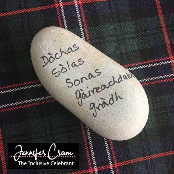 Oathing Stone with commitments written in Gaelic
                  lying on the Scottish Nation Tartan
